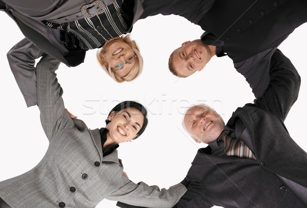 Businessteam standing in huddle, smiling Stock photo © nyul