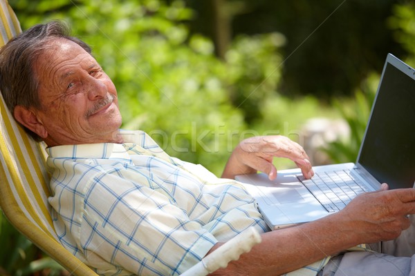 Senior man using laptop outdoor Stock photo © nyul