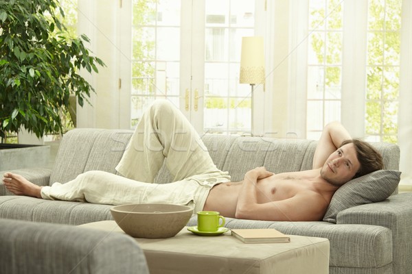 Young man resting on couch Stock photo © nyul