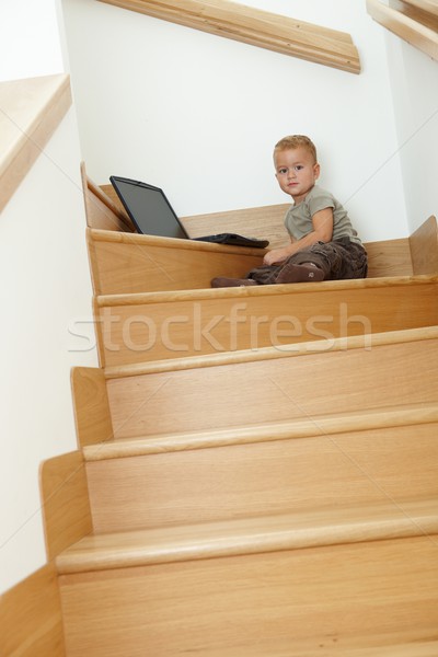 Küçük oturma merdiven erkek oynama dizüstü bilgisayar Stok fotoğraf © nyul