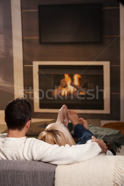 человека сидят камин пару диван домой Сток-фото © nyul