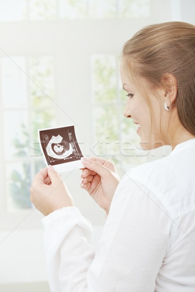 Pregnant woman holding sonogram Stock photo © nyul