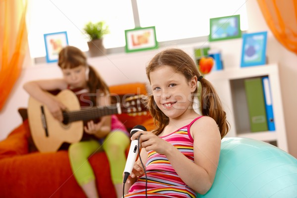 Stock photo: Young girls having fun with music