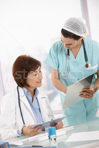 Nurse and senior doctor analysing diagnosis Stock photo © nyul
