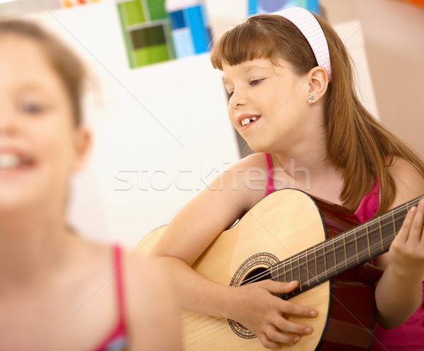 Młoda dziewczyna gry gitara uśmiechnięty domu Zdjęcia stock © nyul