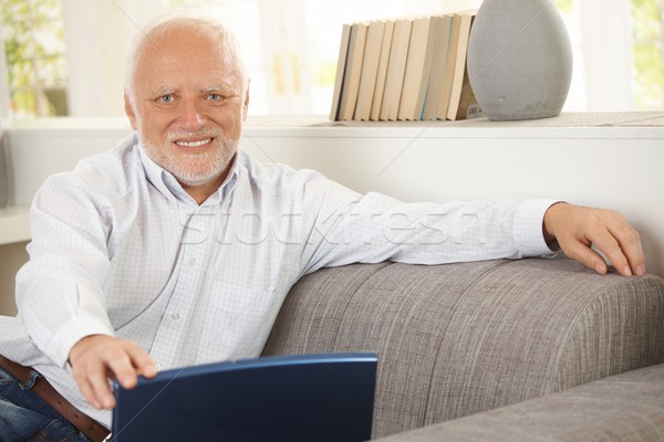 Portret starszych człowiek posiedzenia sofa Zdjęcia stock © nyul