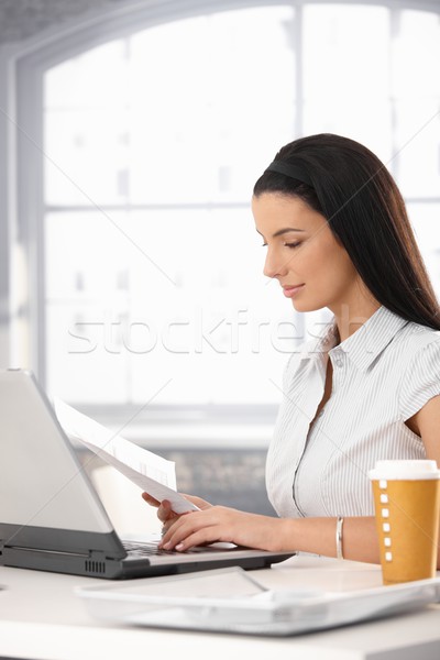 Businesswoman reviewing document Stock photo © nyul