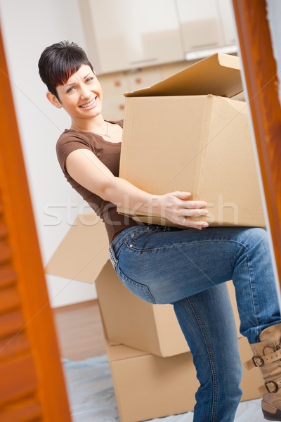 Young woman lifting cardboard box Stock photo © nyul