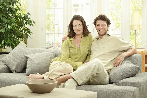 Fiatal pér otthon boldog ül együtt kanapé Stock fotó © nyul