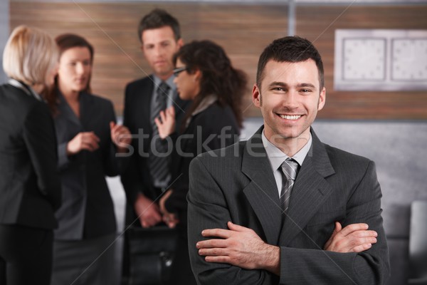 Stock photo: Happy businessman in front of team