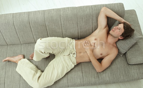 Young man resting on couch Stock photo © nyul