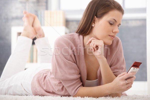 Daydreaming woman using cellphone Stock photo © nyul