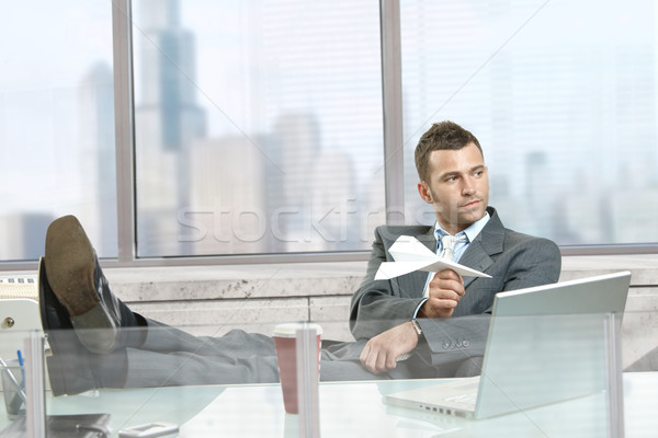 Businessman playing with paper airplane Stock photo © nyul