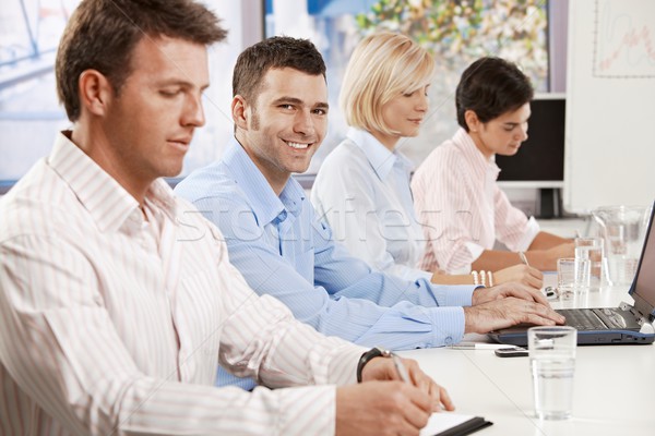 üzletember üzleti megbeszélés boldog fiatal ül kollégák Stock fotó © nyul