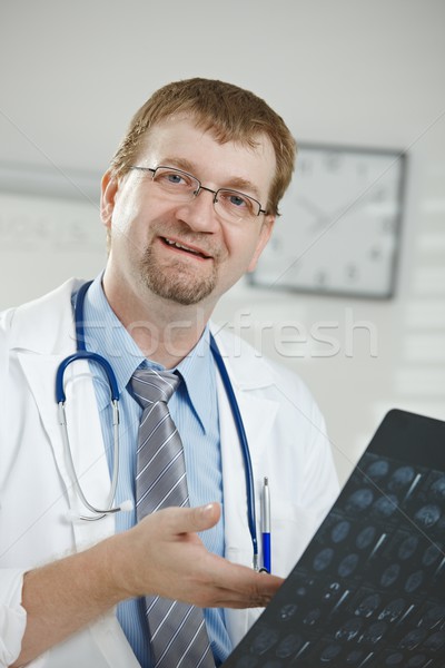 Doctor looking at medical scan Stock photo © nyul