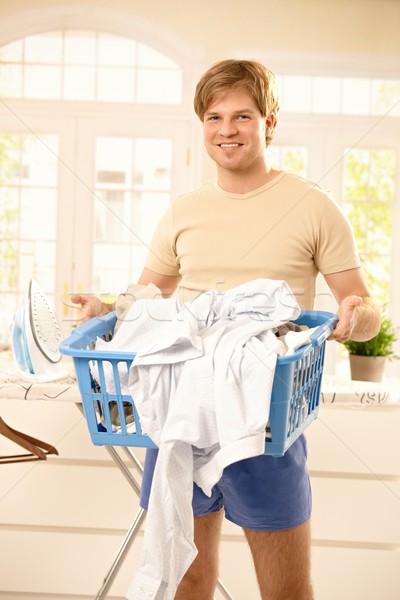 Smiling guy with laundry basket Stock photo © nyul