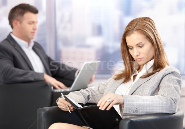 Young businesswoman looking at organizer Stock photo © nyul