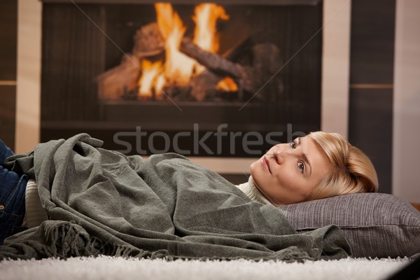 Woman resting beside fireplace Stock photo © nyul