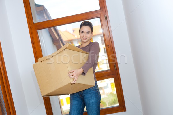 Young woman lifting cardboard box Stock photo © nyul