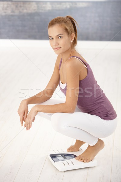 Pretty woman squat on scale Stock photo © nyul