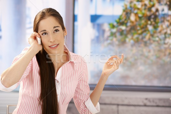 Stock photo: Girl concentrating on phone call
