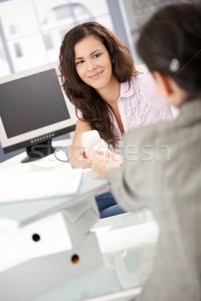 Pretty girl passing phone to colleague in office Stock photo © nyul