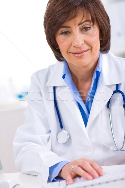 Female doctor working at office Stock photo © nyul