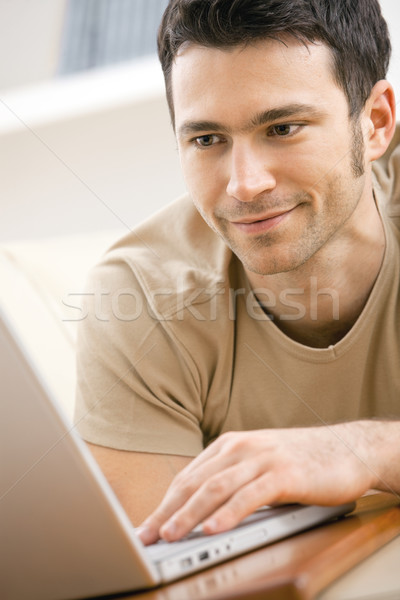 Man using laptop computer at home Stock photo © nyul
