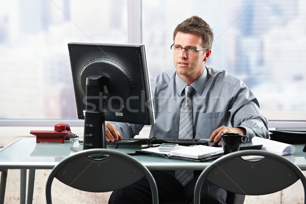 Businessman working at office desk Stock photo © nyul