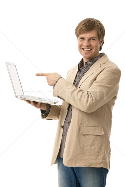 Young man holding laptop with blank screen Stock photo © nyul