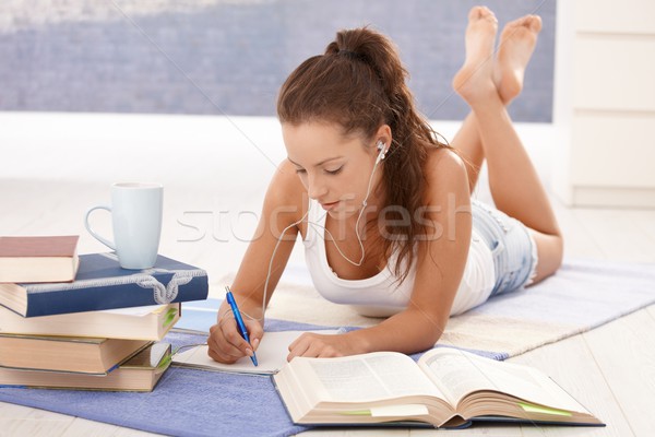 Pretty girl learning at home laying on floor Stock photo © nyul