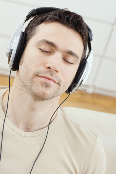Stock photo: Man listening music with headphones