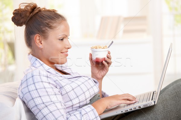 Young woman browsing Internet in bed smiling Stock photo © nyul