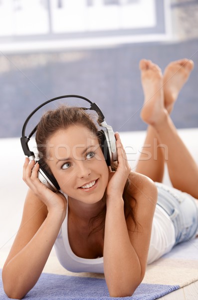 Pretty girl listening music laying on floor Stock photo © nyul