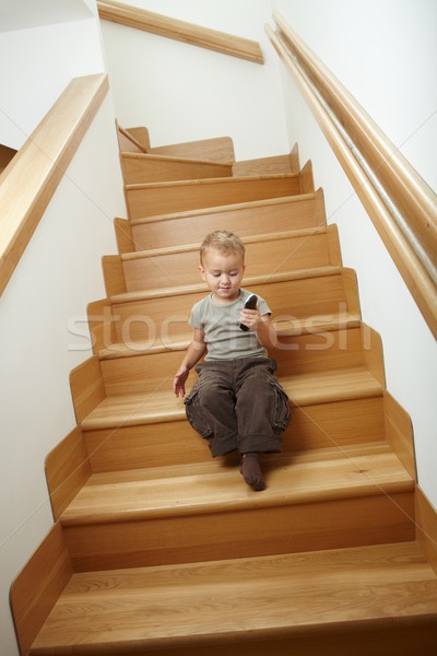 Küçük erkek oturma merdiven oynama taşınabilir Stok fotoğraf © nyul