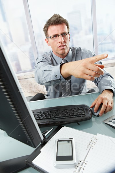Businessman calling and gesturing in office Stock photo © nyul