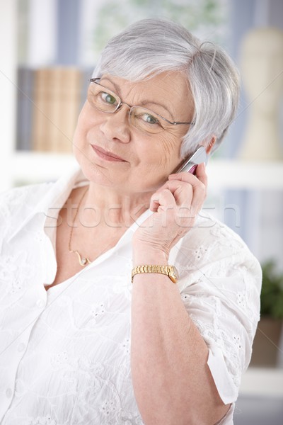 Cheerful senior woman talking on mobile Stock photo © nyul