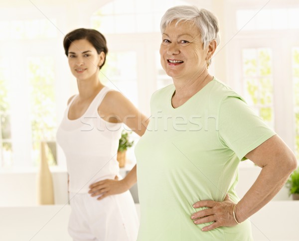 Stock photo: Elderly woman doing exercises with trainer