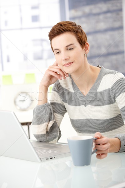Young woman reading on laptop Stock photo © nyul