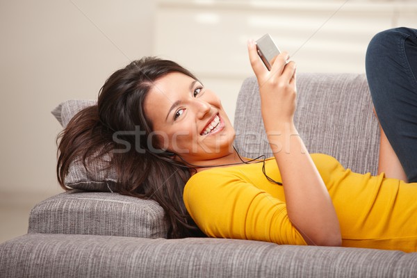 Stock foto: Mädchen · glücklich · halten · Telefon · Sofa · home · glücklich