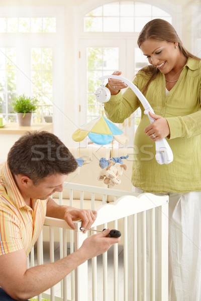 Couple fixing baby bed together Stock photo © nyul