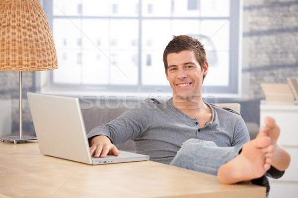 Portrait of young guy at home with computer Stock photo © nyul