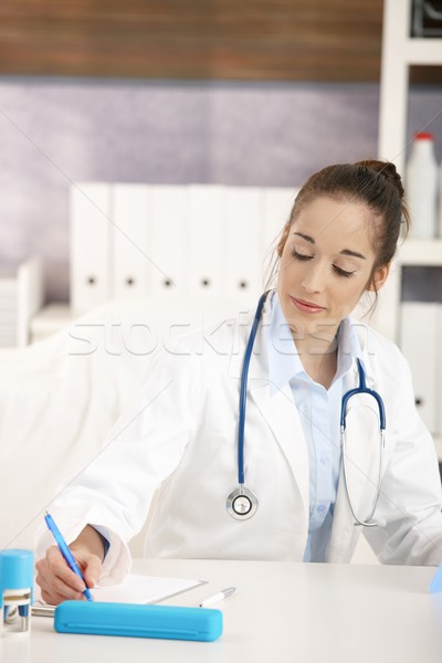 Stock photo: Young female doctor working at desk