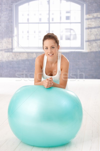 Attractive woman leaning on fitball after workout Stock photo © nyul