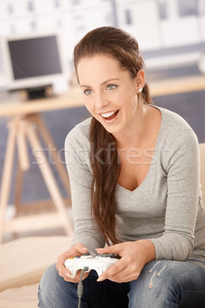 Attractive girl playing computer game at home Stock photo © nyul