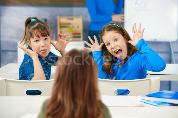 Girls pulling faces in class Stock photo © nyul