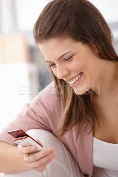 Happy woman texting on mobile phone Stock photo © nyul