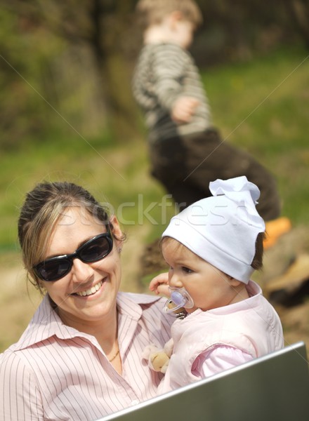 Mother uses a laptop Stock photo © nyul