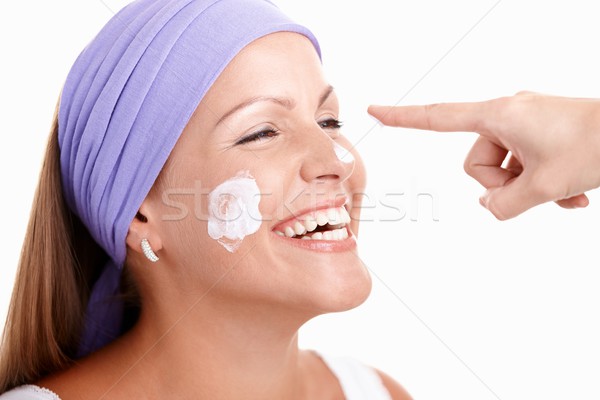 Stock photo: Portrait of attractive young female applying cream