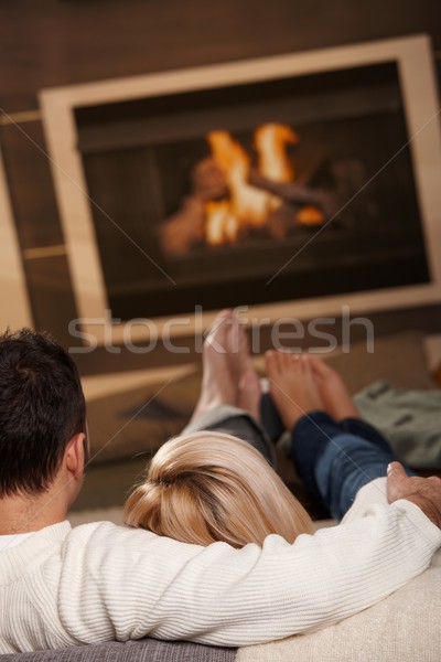 Férfi ül kandalló pár kanapé otthon Stock fotó © nyul